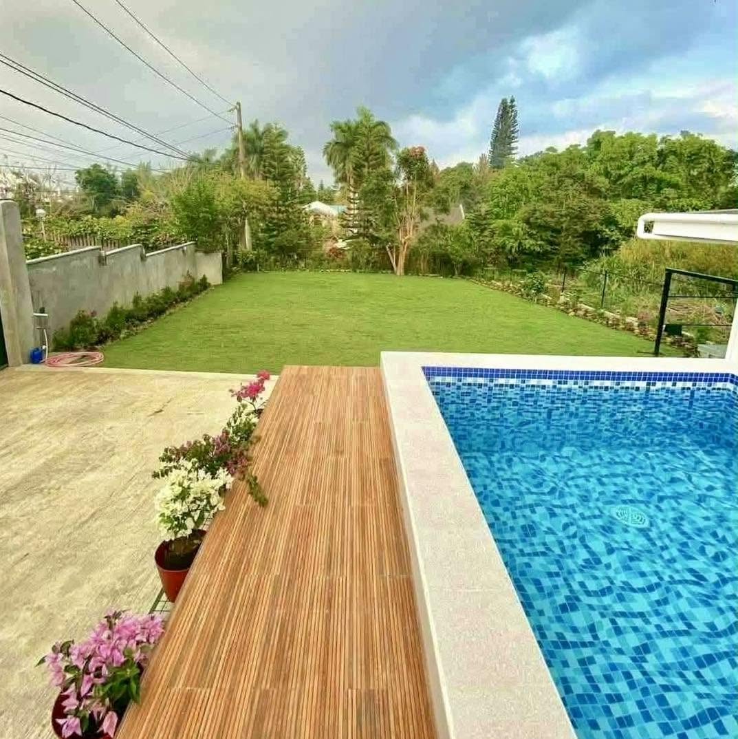 Pool deck overlooking the green resort lawn
